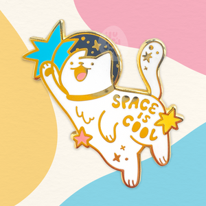 A white cat pin that says space is cool. Made by jushmu